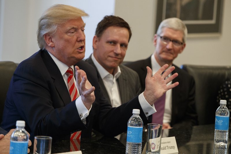 Apple CEO Tim Cook (right) and PayPal founder Peter Thiel were among technology industry leaders meeting with President-elect Donald Trump on Wednesday at Trump Tower in New York.