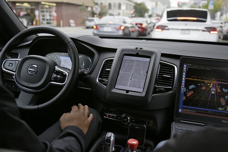 In this photo taken Tuesday, Dec. 13, 2016, an Uber driverless car waits in traffic during a test drive in San Francisco. 