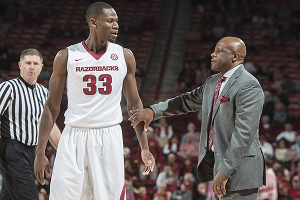Arkansas head coach Mike Anderson talks with Moses Kingsley (33) of Arkansas between plays against Houston Tuesday, Dec. 6, 2016 at Bud Walton Arena in Fayetteville. The Razorbacks won 84-72.