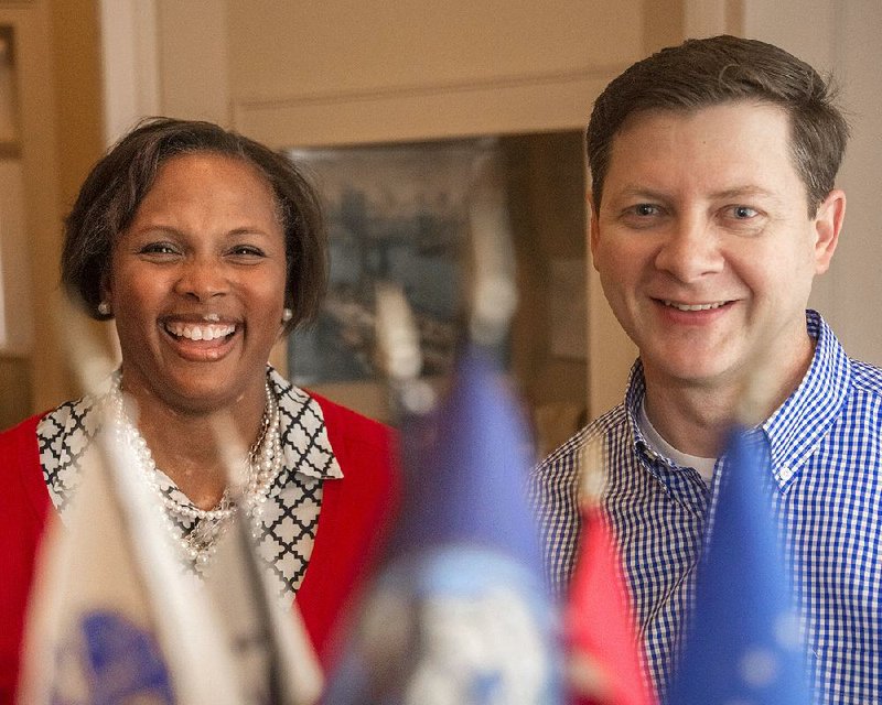Former “helper bees” Latese and James Rowell pose behind flags at the MacArthur Museum of Arkansas Military History. The couple stepped up to be presidents of the U.S. Naval Academy Parents Club of Arkansas this year. The club is hosting the annual All Service Academies Holiday Celebration on Dec. 30.
