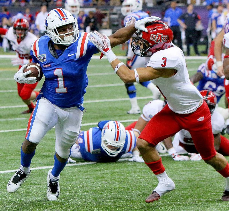 Former Louisiana Tech standout and current Baltimore Ravens running back Kenneth Dixon (left), of Strong, had 215 yards of total offense and scored four touchdowns in the Bulldogs’ 47-28 victory over Arkansas State in last year’s New Orleans Bowl. ASU has lost 11 of its 14 games against non-Sun Belt Conference teams over the past three seasons, including back-to-back losses in bowl games. The Red Wolves will get an opportunity to improve on that mark today against Central Florida in the Cure Bowl.