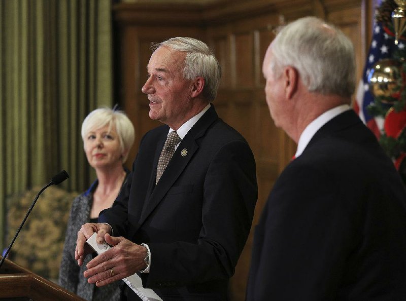 “Here we are at the final hour without action by the Legislature,” Gov. Asa Hutchinson said Friday in announcing the state takeover of seven youth lockups. With Hutchinson are Department of Human Services Director Cindy Gillespie and Larry Walther, director of the Department of Finance and Administration.