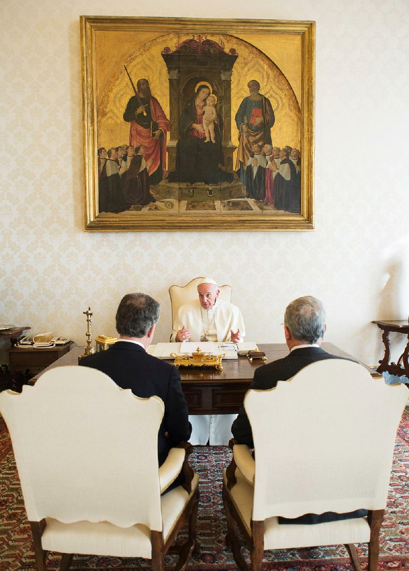 Pope Francis confers with Colombian President Juan Manuel Santos (left) and former President Alvaro Uribe on Friday at the Vatican. “President Santos presented some arguments … then I said, ‘Holiness, tell him to loosen up a bit,’” Uribe said after the 25-minute meeting.