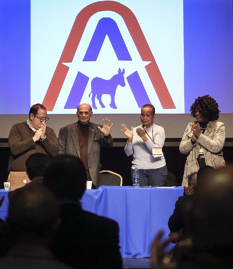 Arkansas Democratic Party Chairman Vince Insalaco (center left) thanks party members Saturday at North Little Rock’s Argenta Community Theater after the state committee voted against electing new leaders before the 2018 gubernatorial election. Insalaco said last week that he will not seek another term, and some Democrats had sought to choose new leadership sooner.