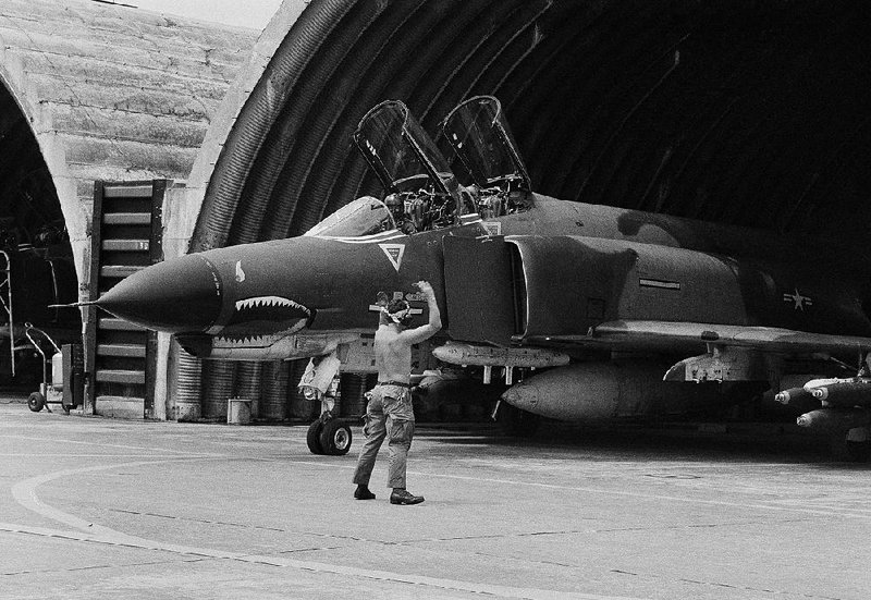 During the Vietnam War, a U.S. Air Force F-4 Phantom jet is guided out of its revetment in Da Nang, then in South Vietnam, at the start of a bombing mission over the DMZ and North Vietnam, in this April 23, 1966 file photo.