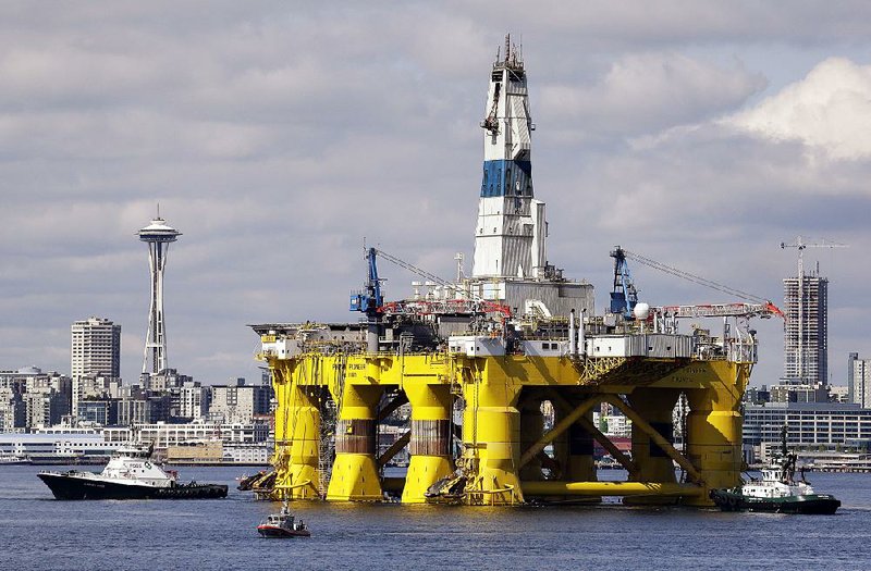 The oil drilling rig Polar Pioneer is towed toward a dock in Elliott Bay in Seattle in this 2015 file photo. 