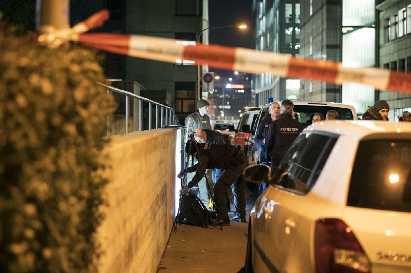 Police secure the area around a mosque in Zurich as a forensic team works in front of it Monday after a shooting.