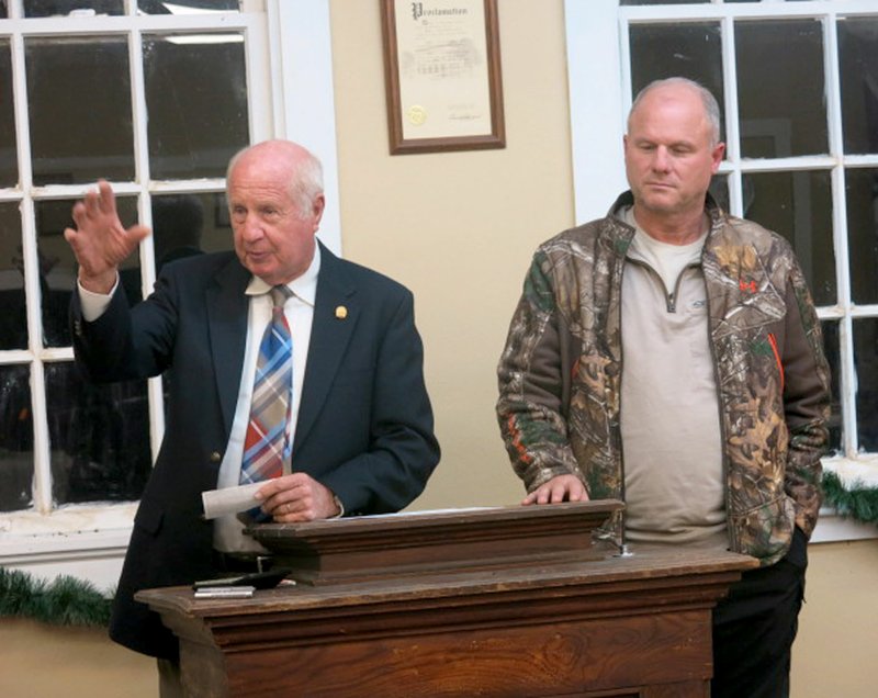 Photo by Susan Holland State representative Kim Hendren (left) and his son, Senator Jim Hendren, addressed the members of the Sulphur Springs city council and guests at their meeting Dec. 15. Both praised Sulphur Springs residents for their progress and improvements in the town and both expressed their pride in living and working there. Further progress is expected with projects to do further cleanup and construct a new highway coming soon.