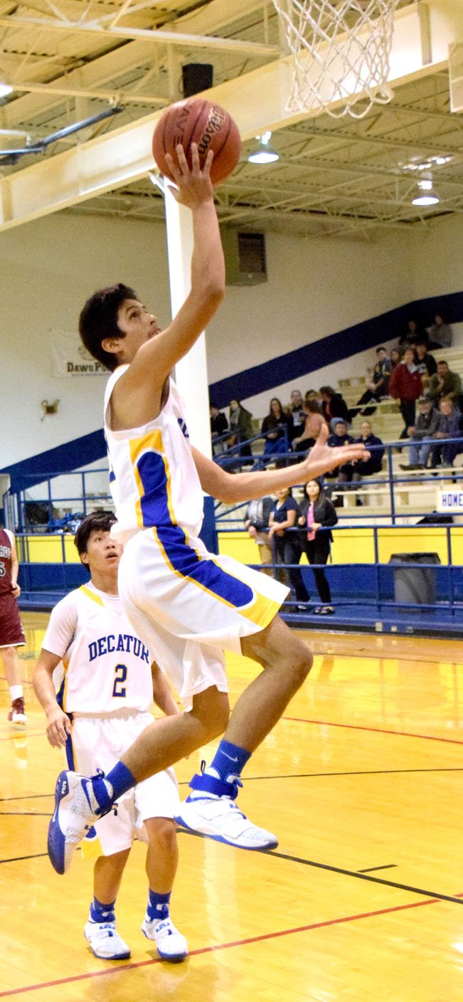 Photo by Mike Eckels Decatur&#8217;s Jimmy Mendoza gets serious air time as he goes for a layup during the final minute of the Decatur-Alpena basketball contest at Peterson Gym in Decatur Dec. 13. Mendoza&#8217;s layup hit its mark for two points.