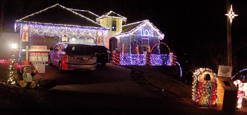 Keith Bryant/The Weekly Vista Bill Robinson&#8217;s heavily-illuminated home on Frampton Lane operates with a laptop computer, Robinson said, that allows him to sync the lights to music he plays and broadcasts.