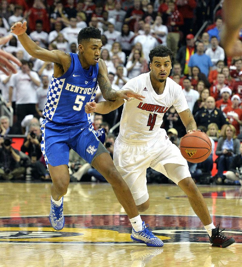 Louisville’s Quentin Snider (4) drives to the basket past Kentucky’s Malik Monk (Bentonville) during the No. 10 Cardinals’ 73-70 victory over the No. 6 Wildcats. Snider finished with a career-high 22 points.
