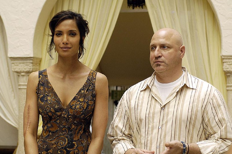 Restaurateur Tom Colicchio of Bravo’s Top Chef (on right, pictured with Padma Lakshmi) tested a no-tipping policy at his Craft restaurant, but found it unfeasible.
