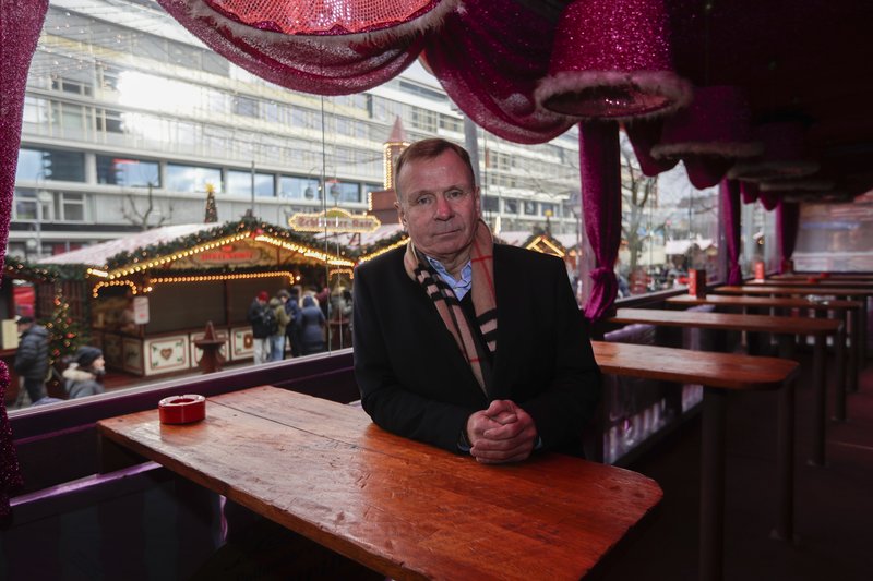 Eye witness Axel Kaiser poses for a photo at his restaurant at the reopened Christmas market, three days after a truck ran into the crowd and killed several people, at the Kaiser Wilhelm Memorial Church in Berlin, Thursday, Dec. 22, 2016. The restaurant's name is 'Christmas Terrace'. 