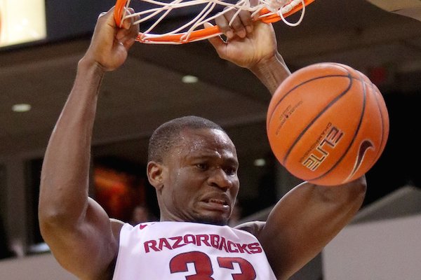 Arkansas' Moses Kingsley slams the ball during the first half of their game Thursday at Verizon Arena in North Little Rock.