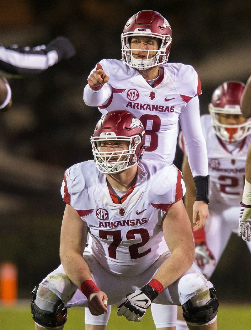Arkansas center Frank Ragnow (72) pulled a prank on quarterback Austin Allen (8) when it came to Ragnow’s decision to return to Arkansas earlier this week. Before the announcement was made, Ragnow sent a text message to Allen saying he was turning pro.