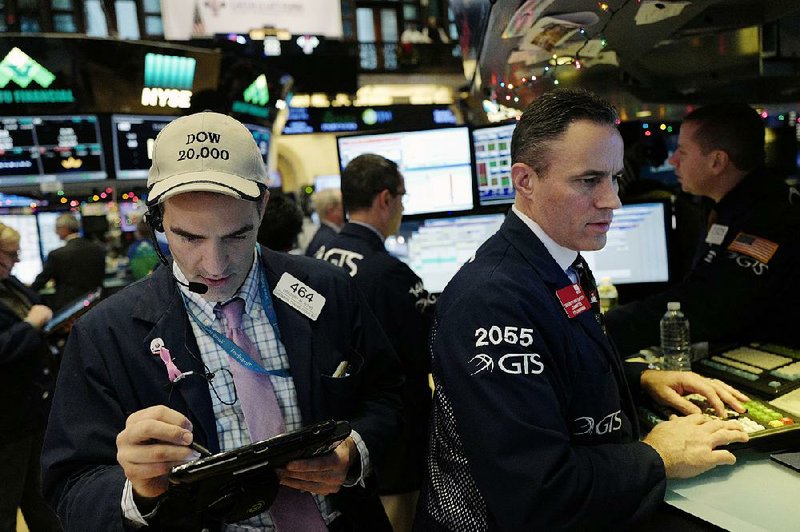 Traders work Thursday on the floor of the New York Stock Exchange, where trading was light just a few days before Christmas.