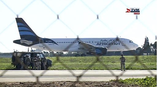 In this frame grab taken from television a hijacked Afriqiyah Airways A320 sits on the tarmac at Malta International airport Friday Dec. 23, 2016. Malta's state television says two hijackers who diverted a Libyan commercial plane to the Mediterranean island nation have threatened to blow it up.