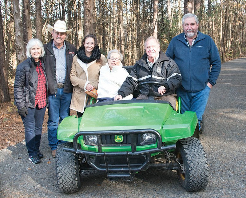 From left, Jo Price, president of the Greers Ferry Lake Trails Council; Cleburne County Judge Jerry Holmes; Nikki Anderson; Pauline Anderson; Heber Springs Mayor Jimmy Clark; and Carl Martin, head of the road department, celebrate the renovation of the Jeff Anderson Memorial Trail. The trail, which was formed in the 1980s after the death of Jeff Anderson, had been overgrown and seen as unsafe in recent years.
