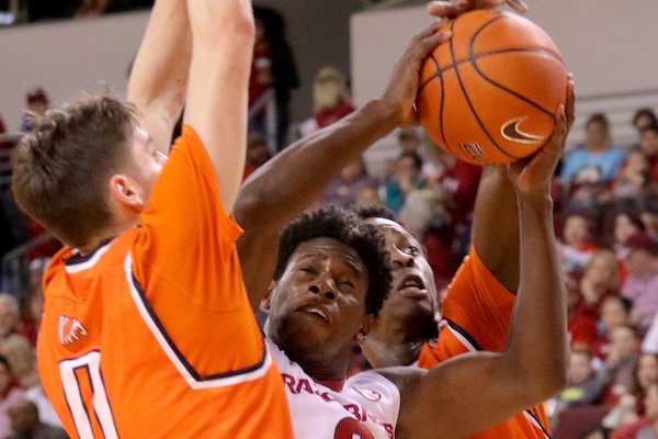 Arkansas' Jaylen Barford, center, battles with Sam Houston State's Albert Almanza, left, and John Dewey Jr., right, during the first half of their game Thursday at Verizon Arena in North Little Rock.