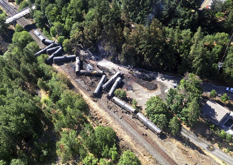 Scattered and burned oil-tank cars block the rail line near Mosier, Ore., after a derailment in early June. 
