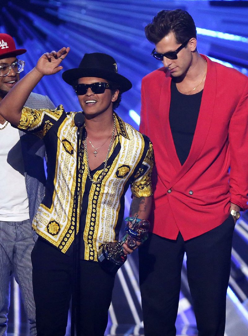 Bruno Mars (left) and Mark Ronson won a number of awards for the song “Uptown Funk.” They are among contemporary artists who are giving credit to past songs in the wake of the “Blurred Lines” case, where Robin Thicke and Pharrell Williams were ordered to pay $5.3 million to Marvin Gaye’s children in a copyright dispute.