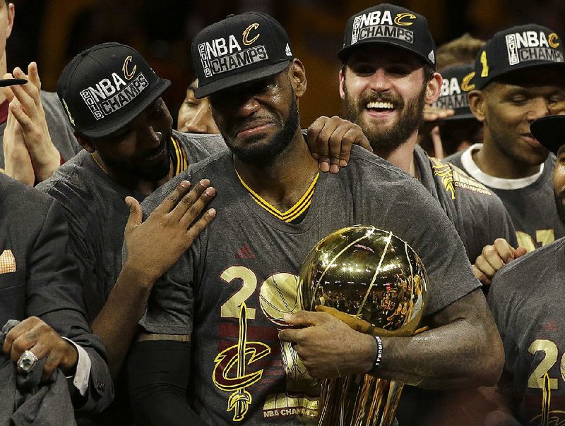 Cleveland players surround forward LeBron James (center) after they beat Golden State 93-89 in Game 7 of the NBA Finals on June 19 to win their first title. The Cavaliers won three games in a row after falling behind 3-1 in the series.