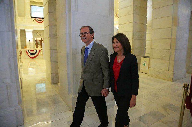 Dan Kemp and his wife, Susan, leave the state Capitol in Little Rock on Nov. 6, 2015, after he fi led paperwork to run for chief justice of the Arkansas Supreme Court. Kemp won the election and will join the court in January.
