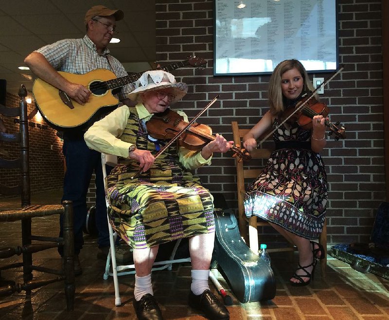 Violet Hensley (center) began playing fiddle as a child in west Arkansas. She is seen here playing in July 2015 with Tim Nelson of Yellville (left) and Clancey Ferguson of Mountain View at the Historic Arkansas Museum in downtown Little Rock.