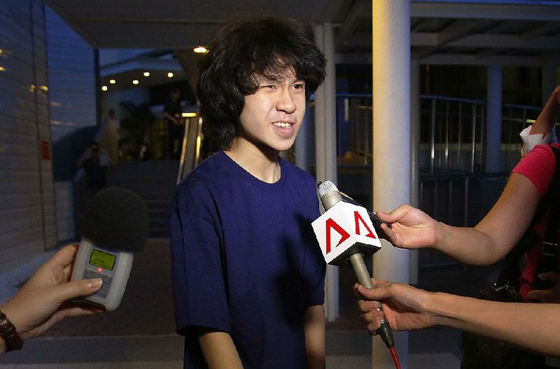 Teen blogger Amos Yee speaks to reporters while leaving the Subordinate Courts in Singapore after being released on bail in 2015.
