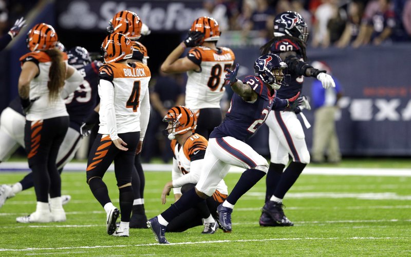 Houston Texans' A.J. Bouye (21) celebrates after Cincinnati Bengals kicker Randy Bullock (4) missed a field as time expired in an NFL football game Saturday, Dec. 24, 2016, in Houston. The Texans won 12-10. 