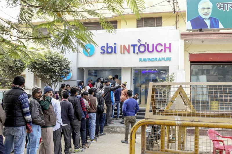 Customers wait in line at a branch of In Touch, operated by State Bank of India Ltd., in Varanasi, Uttar Pradesh, India, on Dec. 9, after Prime Minister Narendra Modi's Nov. 8 decision to ban high-value currency notes. 