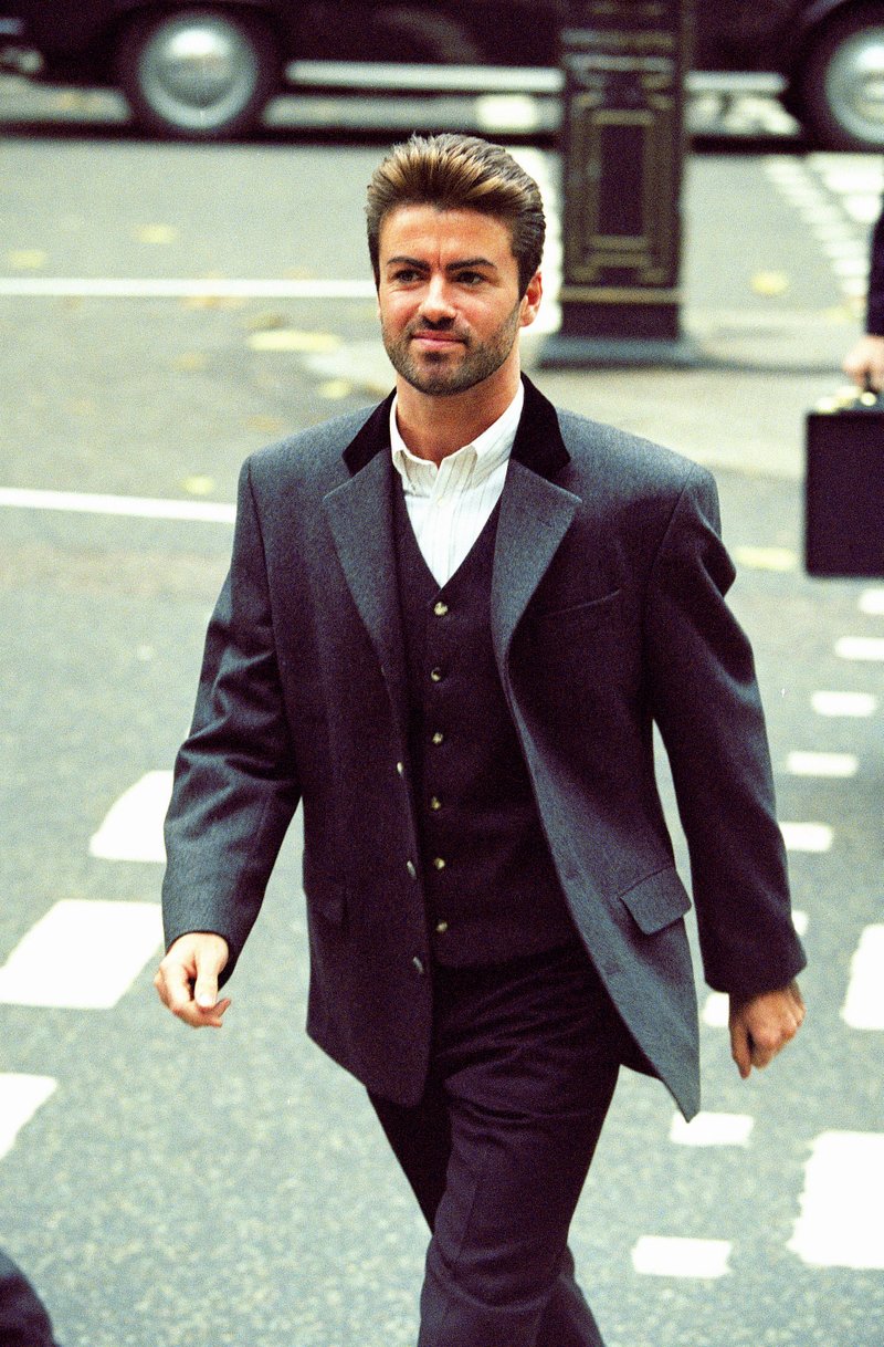 FILE - In this Oct. 28, 1993, file photo, pop star George Michael arrives to give evidence at the Royal Courts of Justice in London. Michael was petitioning the court to release him from his contract with Sony Music Entertainment (UK) Ltd. Michael, who rocketed to stardom with WHAM! and went on to enjoy a long and celebrated solo career lined with controversies, has died, his publicist said Sunday, Dec. 25, 2016. He was 53. (AP Photo/Alistair Grant)