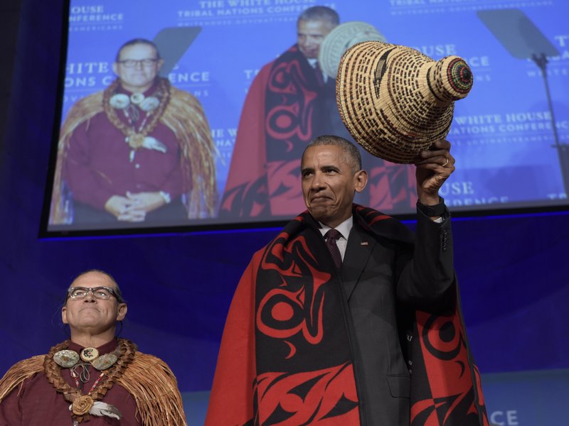 In this Sept. 26, 2016, file photo, President Barack Obama tips he hat as he stands with Brian Cladoosby, President of National Congress of American Indians, at the 2016 White House Tribal Nations Conference in Washington. 