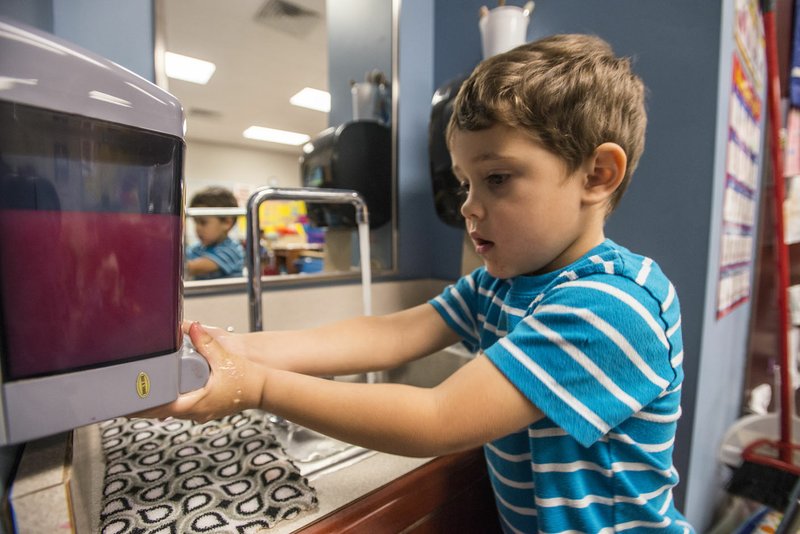 Derek King, 4, a pre-K student, washes his hands Dec. 16 at Knapp Elementary School in Springdale. The children wash their hands often resulting in more than expected water damage to the sinks. The School District is trying to resolve the problem.