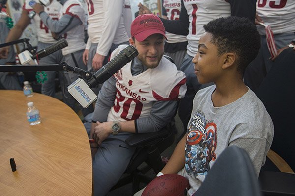 Arkansas receiver Drew Morgan talks with a patient at the Levine Children's Hospital on Tuesday, Dec. 27, 2016, in Charlotte, N.C. Players from Arkansas and Virginia Tech visited the hospital as part of activities leading up to the Belk Bowl. 