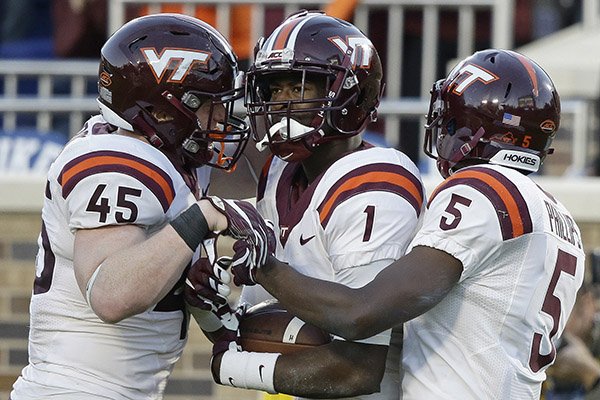 Virginia Tech's Isaiah Ford (1) is congratulated by Sam Rogers (45) and Cam Phillips (5) following Ford's reception against Duke during the second half of an NCAA college football game in Durham, N.C., Saturday, Nov. 5, 2016. Virginia Tech won 24-21. (AP Photo/Gerry Broome)