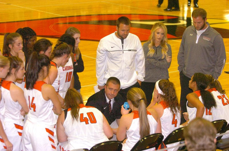 MARK HUMPHREY ENTERPRISE-LEADER Farmington head coach Brad Johnson outlines game strategy during a time-out. The Lady Cardinals came into the Christmas break with an 8-2 record after wins over 7A schools, Bentonville West and Rogers Heritage.