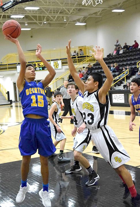 Photo by Mike Eckels Tafari James (Decatur 15) puts up a jumper from inside the lane during the Decatur-Prairie Grove junior high basketball contest at Tiger Arena in Prairie Grove Dec. 15. The junior Bulldogs lost this matchup by 12 points.