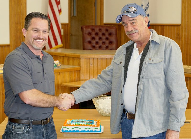 Photo by Randy Moll Kevin Johnston, Gentry&#8217;s mayor, shakes hands with David McNair, the city&#8217;s public works supervisor, Thursday (Dec. 22, 2016) upon McNair&#8217;s retirement after 25 years of service as a city employee and another four or five years of service as a city alderman. Thursday was McNair&#8217;s last day with the city since city employees were off for the Christmas holidays on Dec. 23.