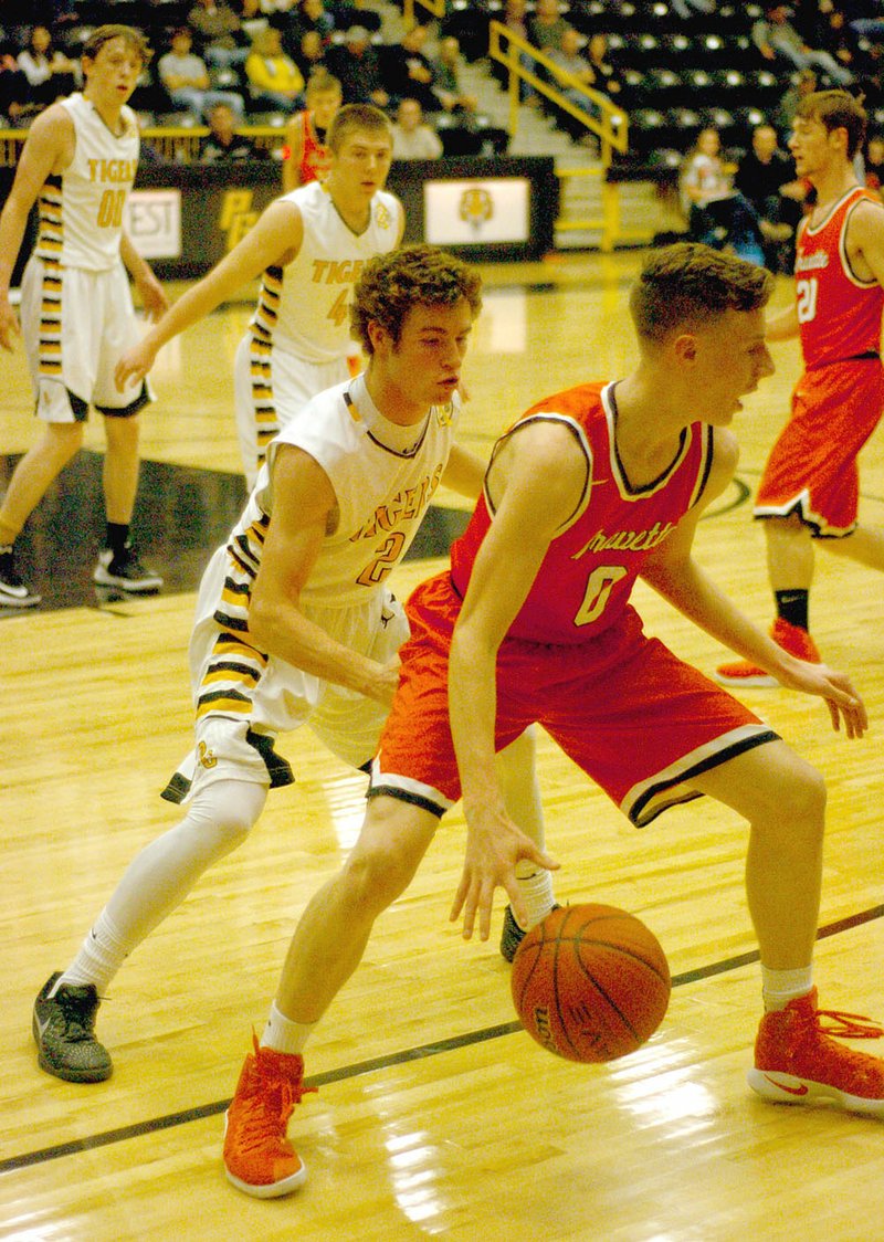 MARK HUMPHREY ENTERPRISE-LEADER Prairie Grove senior Isaac Disney guards Gravette&#8217;s Seth Duke in a December game. Disney has been named male Athlete of the Year at Prairie Grove for 2016 by the Enterprise-Leader. He is described as a &#8220;shut-down&#8221; defender by Tiger coach Steve Edmiston.