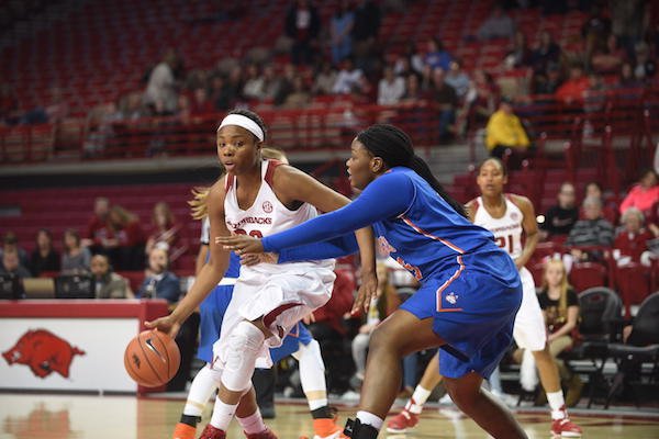 Arkansas' Jessica Jackson (00) dribbles against Houston Baptist defenders during a game Wednesday, Dec. 28, 2016, in Fayetteville. 