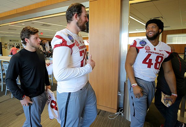 Arkansas defensive end Deatrich Wise (48) talks with teammates Dan Skipper (70) and Austin Allen during Belk Bowl Media Day on Wednesday, Dec. 28, 2016, at BB&T Ballpark in Charlotte, N.C.