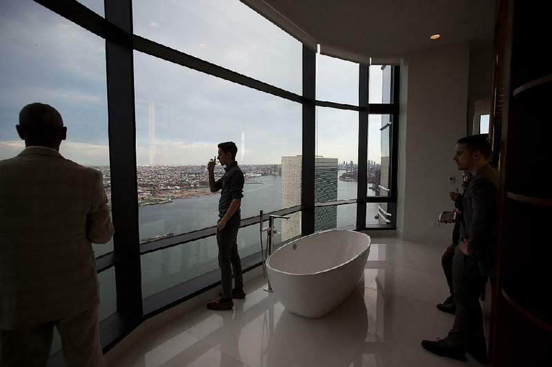 Guests take in the view from the $70 million penthouse at the 50 United Nations Plaza building in New York during a party in June. 