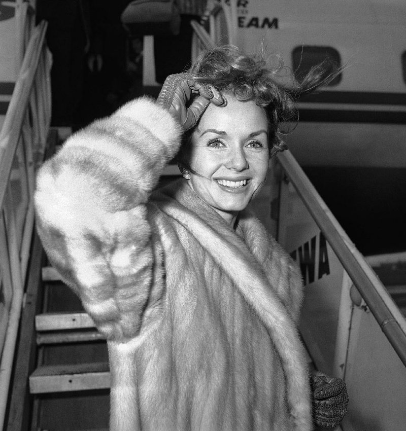 Debbie Reynolds boards a plane in New York on March 6, 1959, for a flight to Spain to film a movie. 