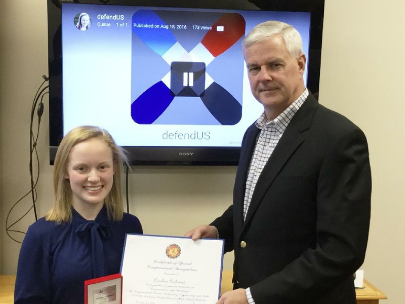 Caroline Gschwend, 18, of Rogers receives a certificate from U.S. Rep. Steve Womack, R-Rogers, on Monday, Dec. 19, 2016, recognizing her as the winner of this year's Congressional App Challenge for Arkansas' 3rd Congressional District. Gschwend's mobile application, a game related to U.S. history, was judged the best of 11 submissions from the 3rd District. Gschwend's app will be displayed at a kiosk in the U.S. Capitol.

