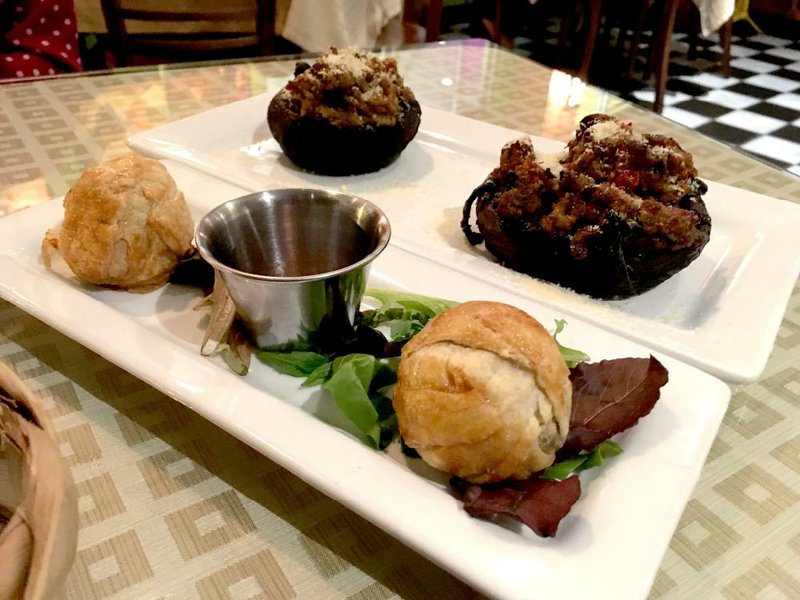 Two Cafe Bossa Nova appetizers — Almondegas (left), pork and beef meatballs in puff pastry, and Cogumelos Recheados, Portobello mushrooms stuffed with spinach and Italian sausage — are large enough to pass for small entrees. 