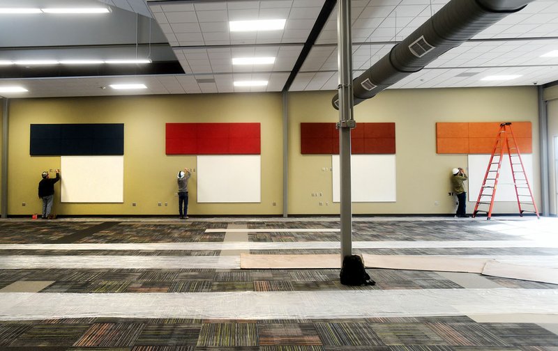 Construction workers put the finishing touches on a new wing Dec. 15 at the Don Tyson School of Innovation in Springdale. The school is significantly expanding the classroom space for its students.