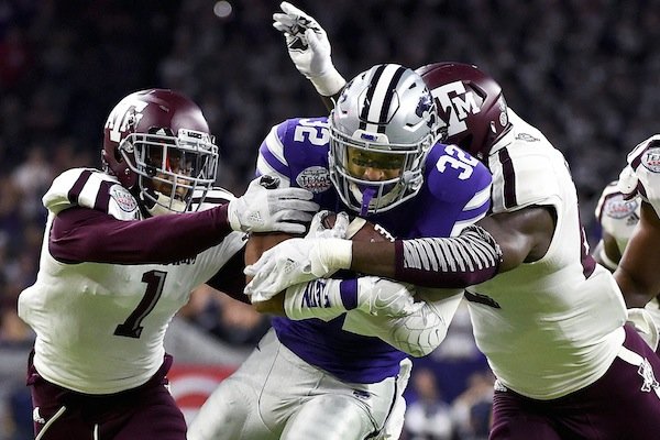 Kansas State running back Justin Silmon (32) is tackled by Texas A&M's Nick Harvey (1) and Clifford Chattman during the first half of the Texas Bowl NCAA college football game, Wednesday, Dec. 28, 2016, in Houston. (AP Photo/Eric Christian Smith)