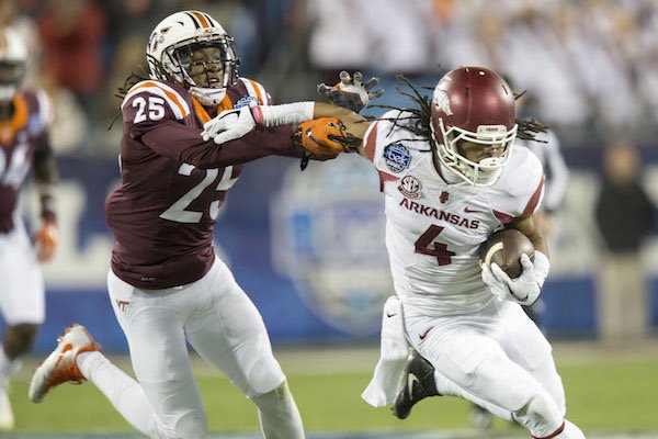 Arkansas wide receiver Keon Hatcher (4) tries to escape Virginia Tech defensive back Terrell Edmunds (25) in the first quarter during the Belk Bowl on Thursday, Dec. 29, 2016, at Bank of America Stadium in Charlotte, N.C.
