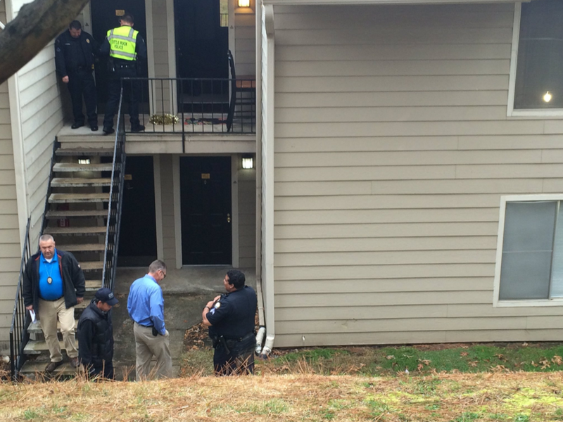 Police investigate outside an apartment where a woman was shot Wednesday afternoon in Little Rock.